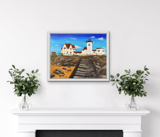 Travel artwork "Eastern Point Light" hands on a white wall above a fireplace.