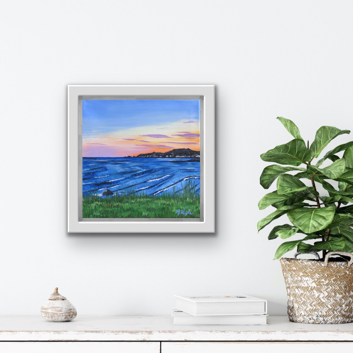 Travel Artwork By Boston Latinx Artist Alexandra Wuyke "Sunset at Rocky Neck" hangs over a fireplace in a living room.